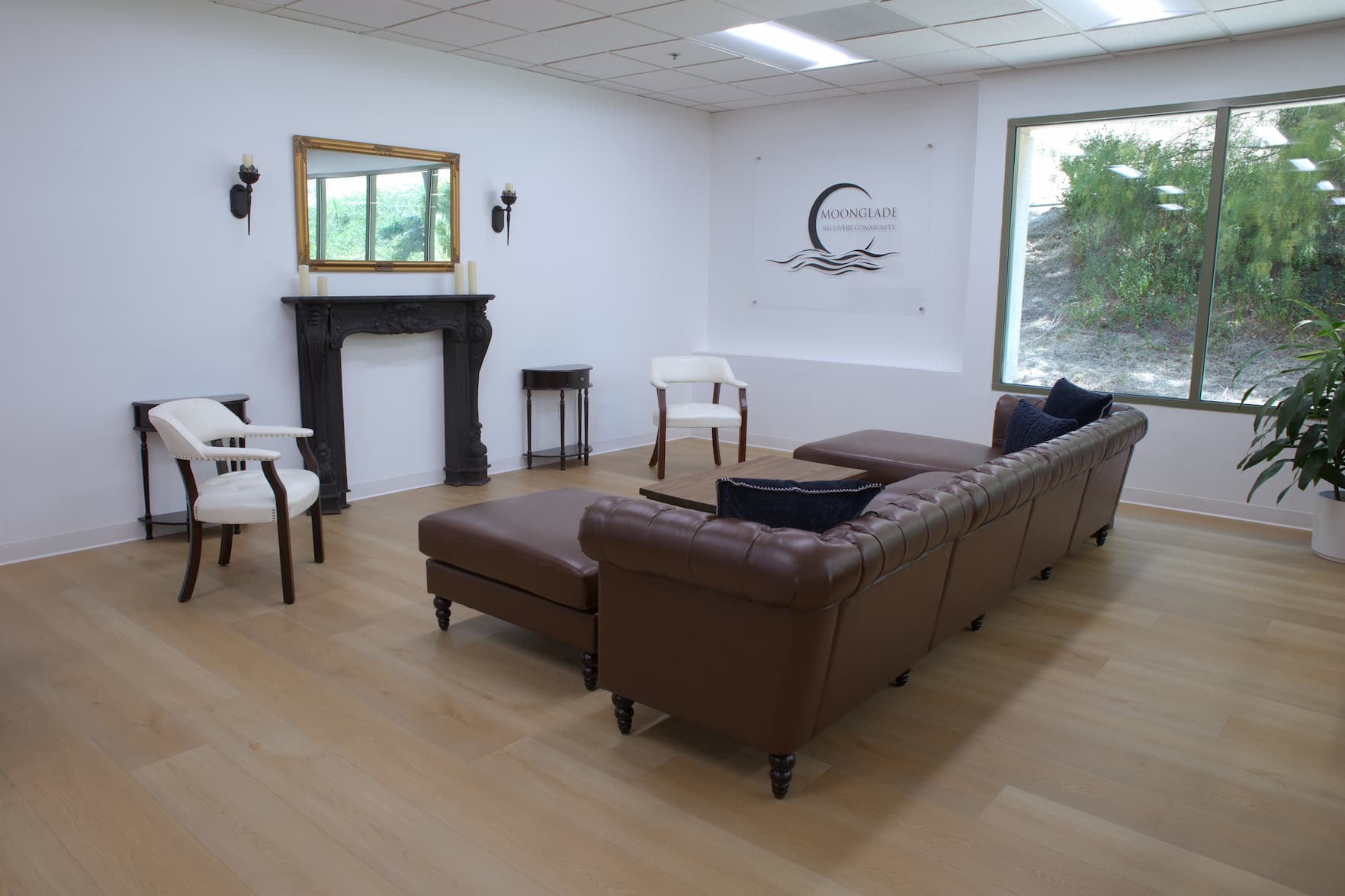 Moonglade's bright group lounge with leather sofas and garden views