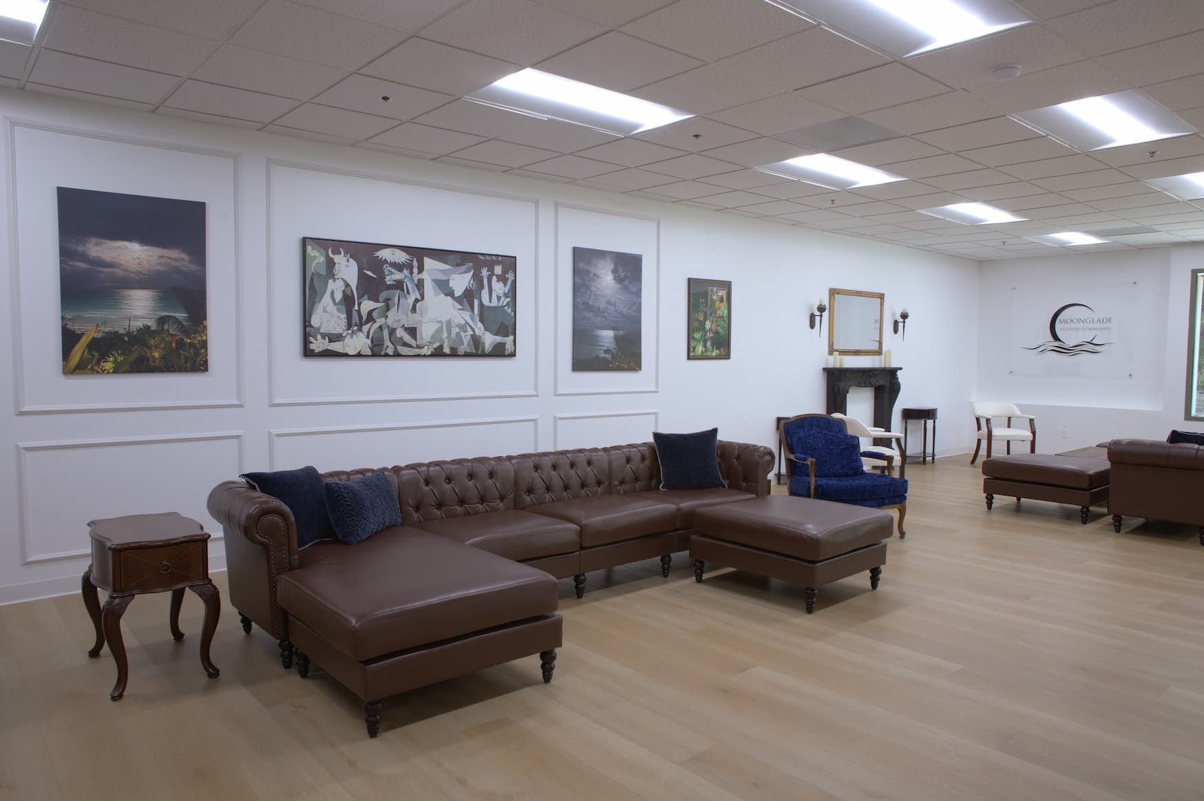 Moonglade Recovery lounge with framed artwork above leather seating and the Moonglade logo on the far wall